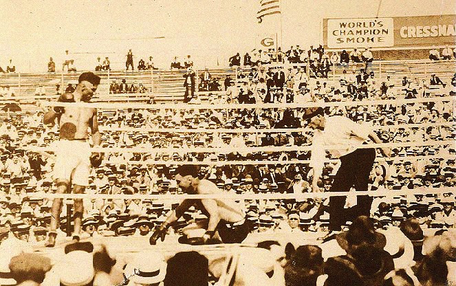 Dempsey stands nearby as Willard rises from the canvas in Toledo, 1919